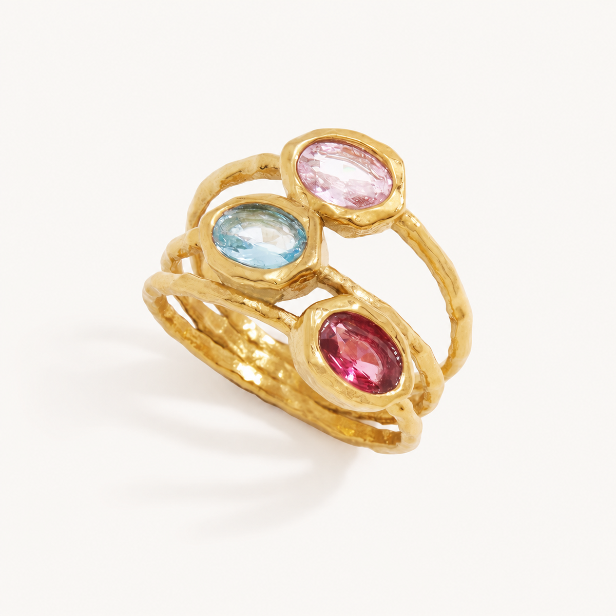 Rosella hammered gold three-row ring with pale pink, aqua blue, and raspberry zircon stones.