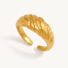 Orlena textured gold adjustable ring with sculpted ridges on warm ivory